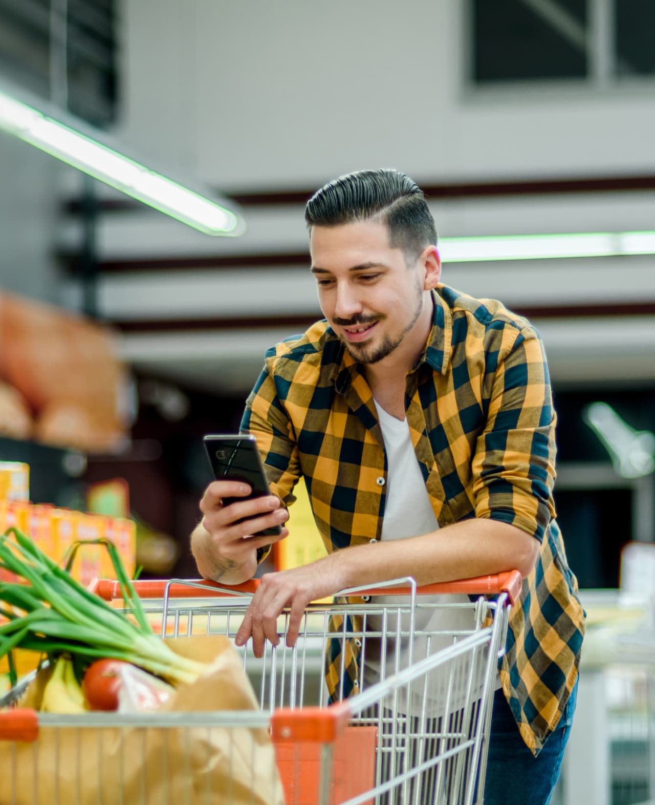 Matlistan shopping holding phone