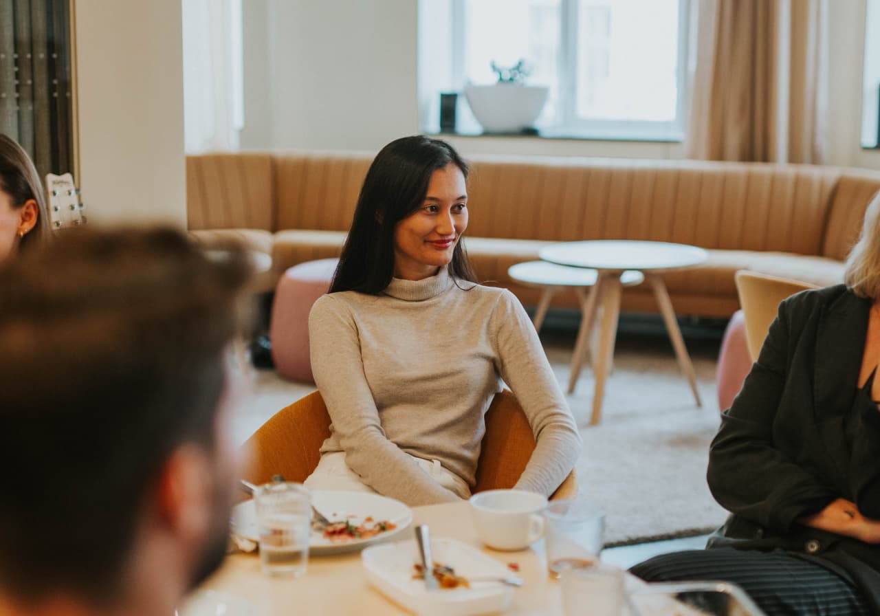 Woman sitting by a table